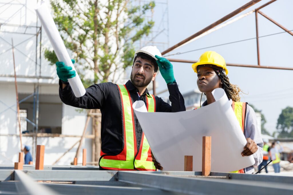 Construction civil engineer man and woman African American checking quality of work in construction